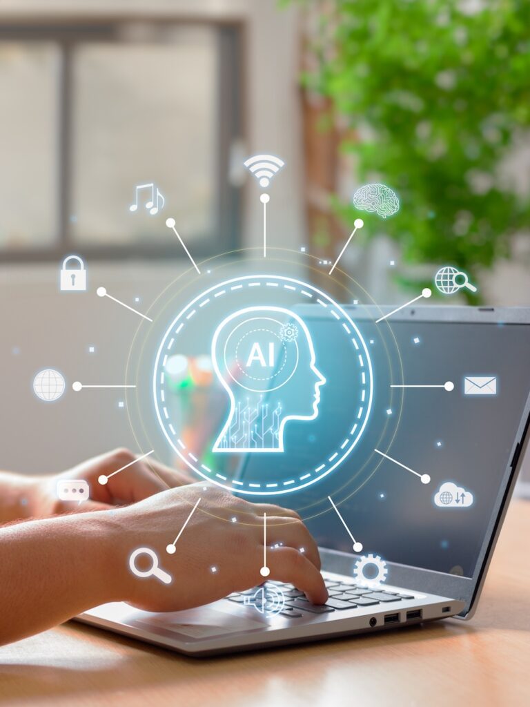 A glowing digital AI interface is overlayed on a laptop as a user types, illustrating the cutting-edge integration of AI automations at Planify Agency. The central brain icon, surrounded by symbols for SEO (Search Engine Optimization), GEO (Generative Engine Optimization), and AEO (Answer Engine Optimization), highlights how the agency leverages advanced technology to enhance search visibility and digital marketing performance. This visual represents the future-forward approach Planify Agency takes in optimizing business workflows and content for the evolving AI landscape.